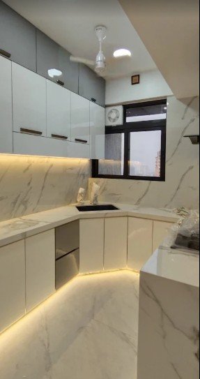 Marble kitchen with warm cove lighting, designed by AV Corporation